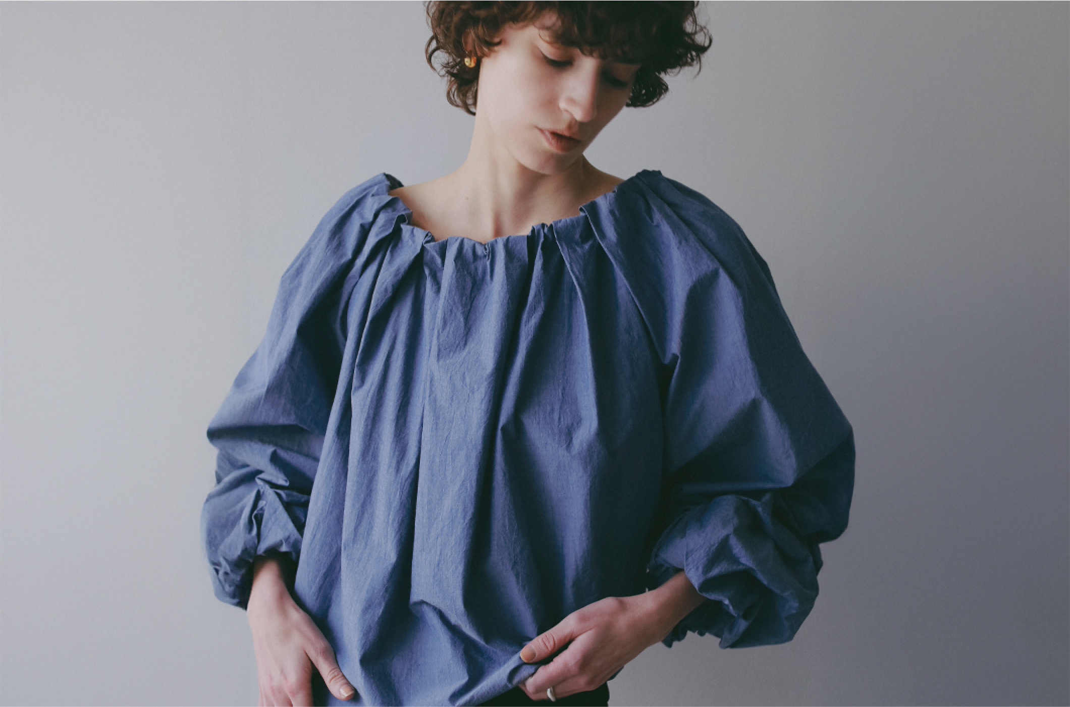 ブルーのブラウスを着用した女性の画像